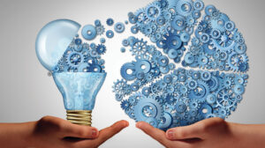 Illustration of two upright cupped hands facing each other one with illustrated light bulb with gears floating to other and forming a pie chart.
