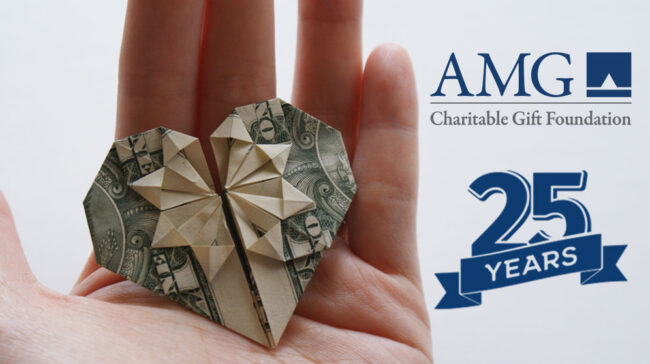 charitable-gift Handing holding US dollar folded into a heart shape with logo for AMG Charitable Gift Foundation and label "25 Years".