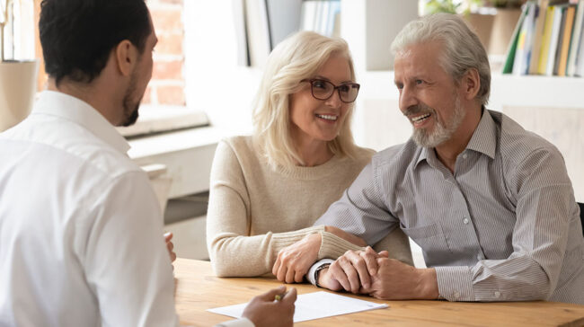 Older couple discussing estate with advisor.