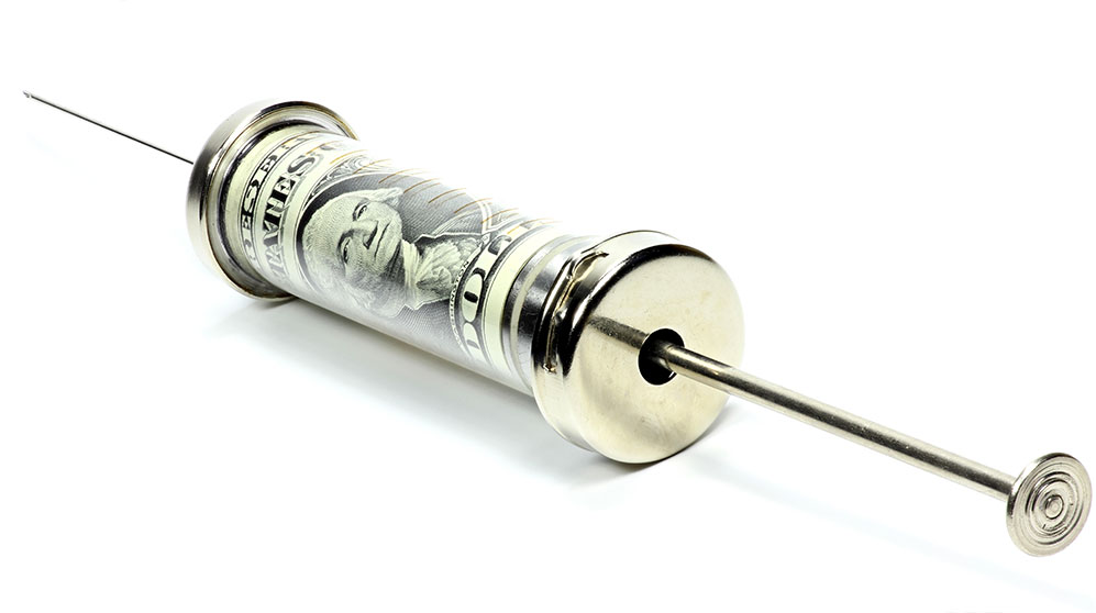 Glass syringe filled with US dollars