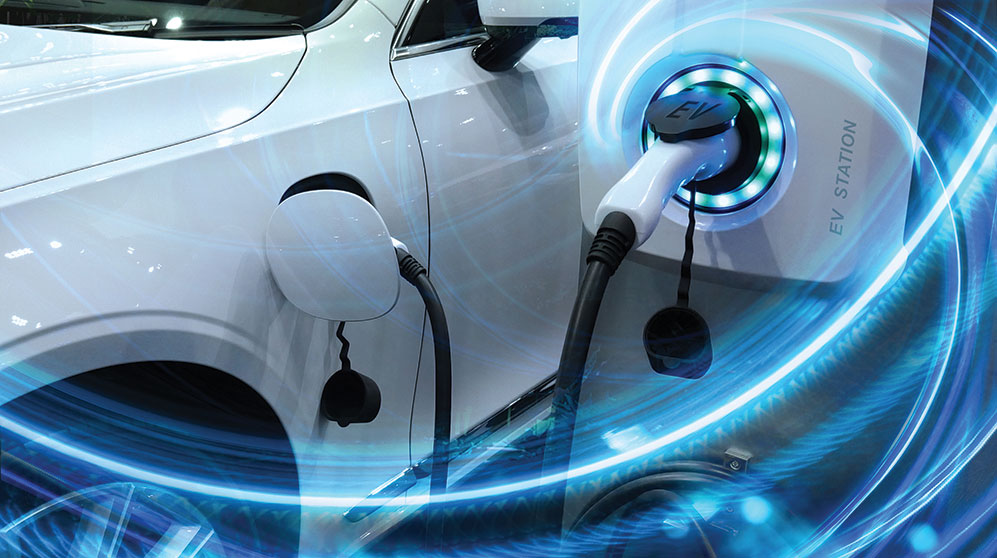 Futuristic glow around an electric car plugged into charger.