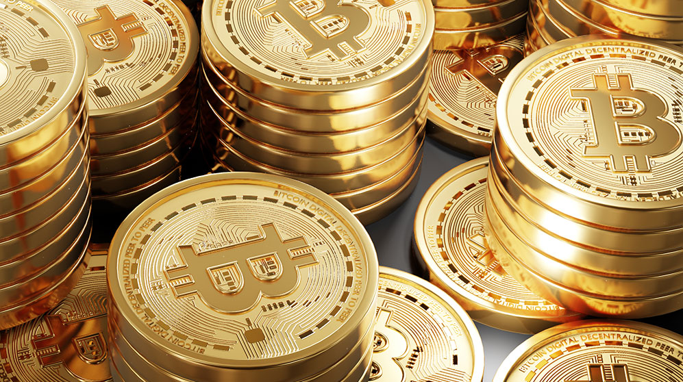Piles of gold coins with bitcoin symbol.