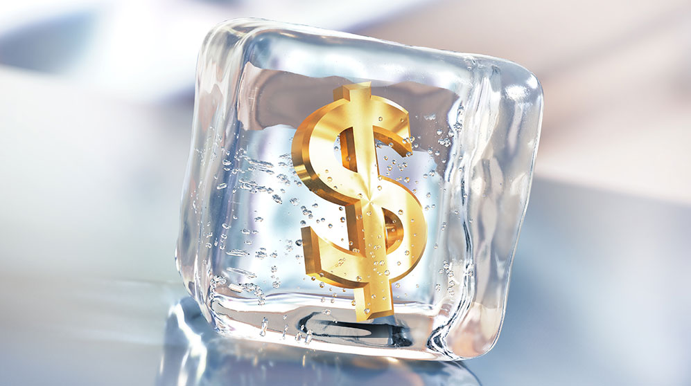 Illustration of a gold dollar sign frozen in an ice cube.