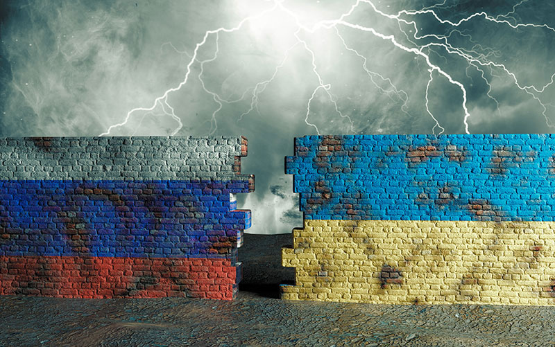 Lighting striking a battered brick wall with a jagged hole in middle colored on left in Russia flag and right in Ukraine flag.
