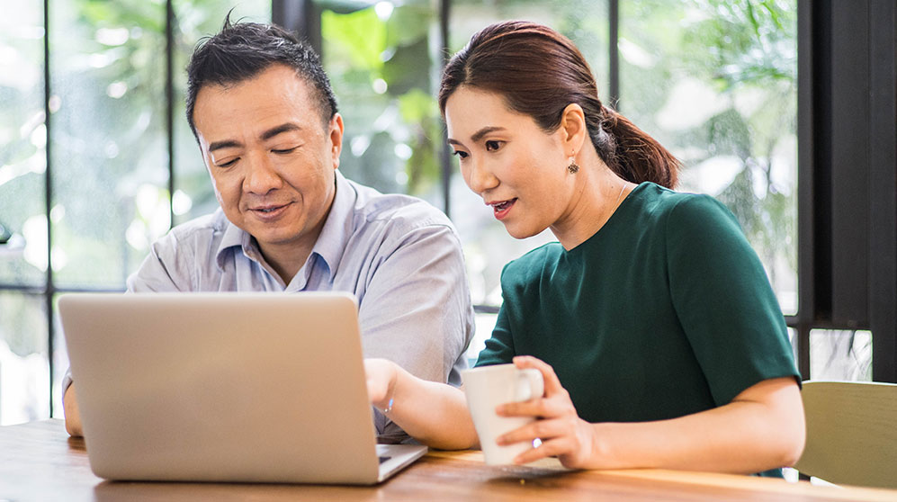 a couple looking at their 401K accounts online