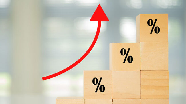 Progressively higher stacked wooden blocks with % label and a red arrow pointing up.