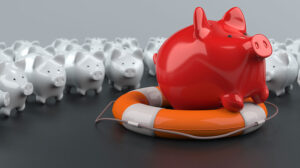 Red piggy bank floating on an orange and white life preserver