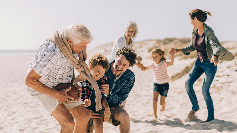 family playing on the beach