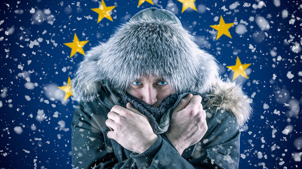 person bundled up in color against the EU flag in the snow