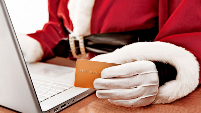 Photo of Santa shopping online for holiday gifts