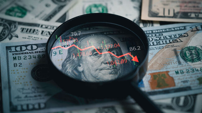 Photo of a magnifying glass over a dollar bill