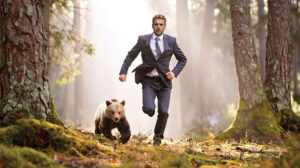 Business man being chased by a bear cub