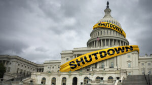 Photo of the capital building with the word "shutdown" in tape around the building
