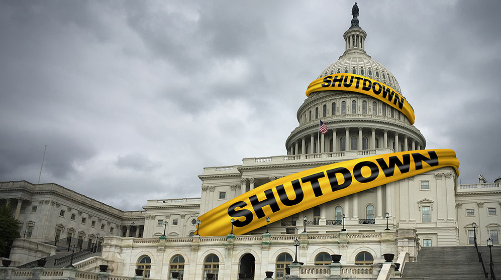 Photo of the capital building with the word "shutdown" in tape around the building