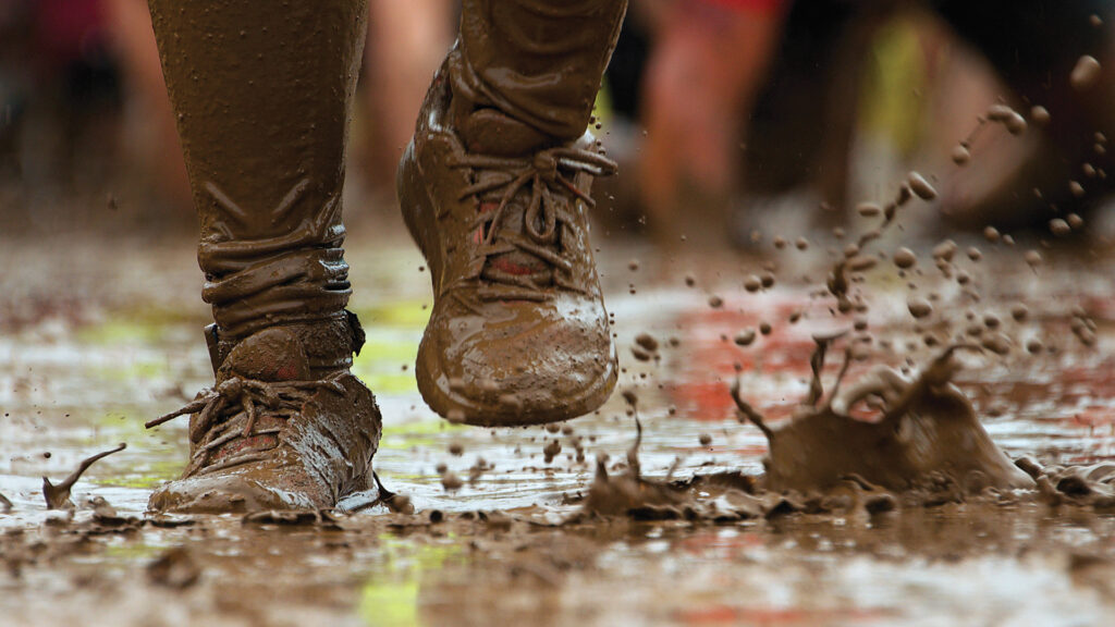Photo of someone running in the mud