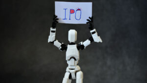 Photo of a robot holding up an "IPO" sign