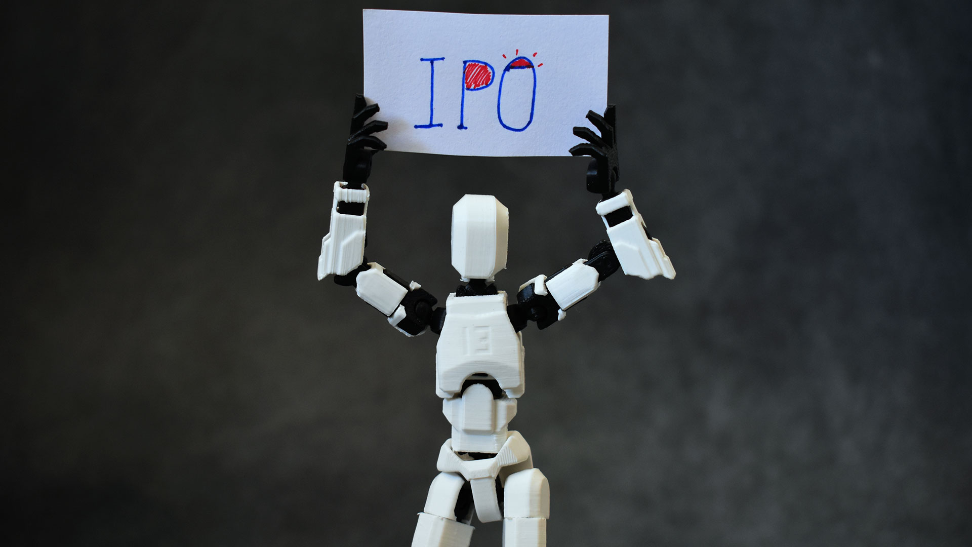Photo of a robot holding up an "IPO" sign